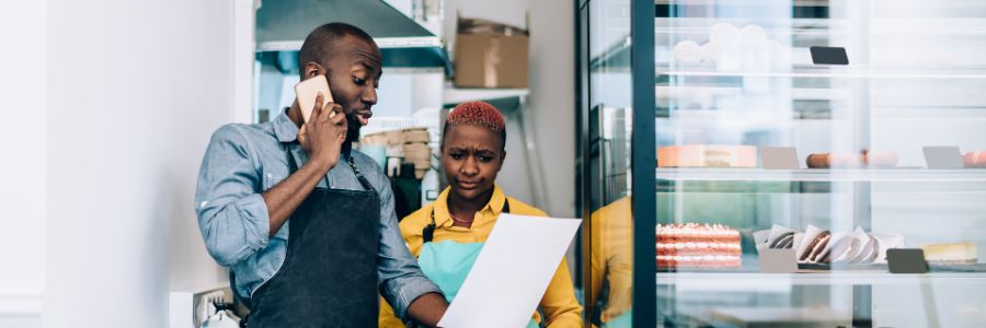 Bakery business owners look over their bakery business plan