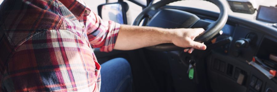 Image of a truck driver driving for his trucking business.